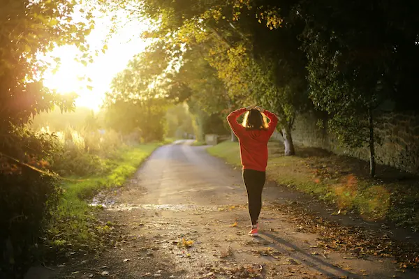 A person running in nature or doing yoga outdoors